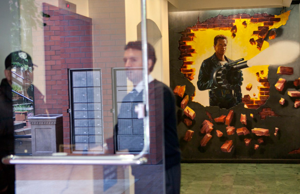 Security guards are shown in the lobby of the office building of former California Governor Arnold Schwarzenegger decorated with a movie themed mural, in Santa Monica, Calif. (AP)