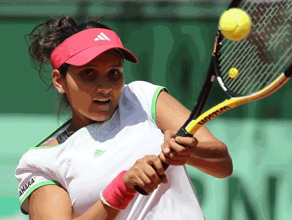 India's Sania Mirza hits a return to Germany's Kristina Barrois during their first round match in the French Open championship at the Roland Garros stadium, on Monday, in Paris. (AFP)