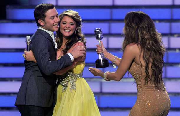 Winner Scotty McCreery, left, hugs finalist Lauren Alaina as Jennifer Lopez hand him his trophy at the "American Idol" finale, in Los Angeles. (AP)
