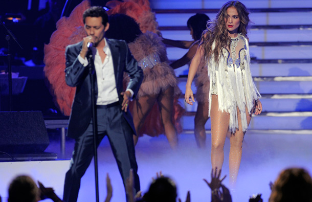 Jennifer Lopez, right, walks onstage as Marc Anthony performs at the "American Idol" finale, in Los Angeles. (AP)
