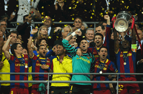 Eric Abidal of FC Barcelona lifts the trophy and celebrates with teammates after victory in the UEFA Champions League final against Manchester United FC at Wembley Stadium on Saturday in England. (GETTY)