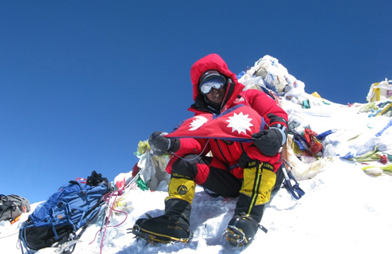 Nepalese climber Apa Sherpa - who holds the record for the number of times Mount Everest has been climbed - unfurls a Nepalese national flag on the summit of Mount Everest on May 11, 2011. (AFP)