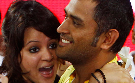 Chennai Super Kings captain Mahendra Singh Dhoni, right, is hugged by his wife Sakshi after his team's win over Royal Challengers Bangalore in the Indian Premier League final cricket match in Chennai, India, Saturday, May 28, 2011. Chennai won by 58 runs. (AP)