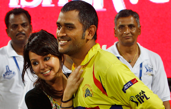 Chennai Super Kings captain Mahendra Singh Dhoni, right, is hugged by his wife Sakshi after his team's win over Royal Challengers Bangalore in the Indian Premier League final cricket match in Chennai, India. (AP)