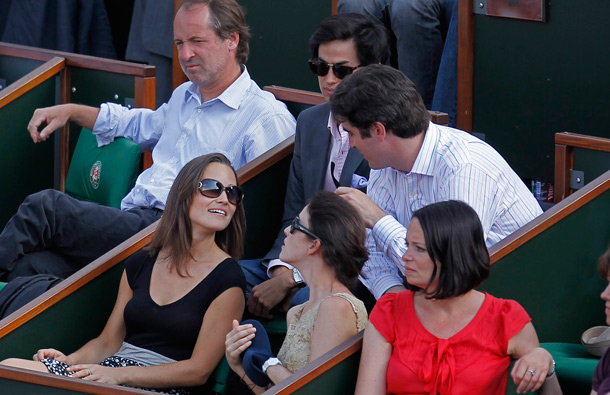 Pippa Middleton, sister of Kate, Duchess of Cambridge, bottom left, chats while watches Sweden's Robin Soderling playing France's Gilles Simon during their fourth round match of the French Open tennis tournament, at the Roland Garros stadium in Paris. (AP)