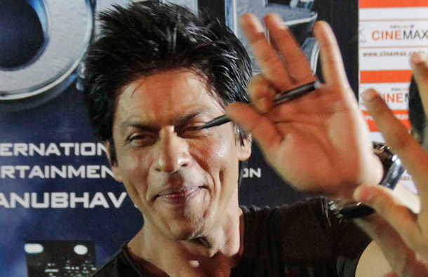 Bollywood actor Shah Rukh Khan waves to fans during a promotion of his upcoming film Ra.One, in Ahmadabad India. Ra.One is a Hindi science fiction superhero film. (AP)