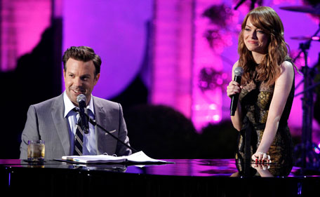 Jason Sudeikis, left, and Emma Stone are seen on stage at the MTV Movie Awards on Sunday, June 5, 2011, in Los Angeles. (AP)