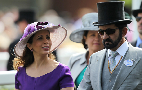 Dubai's Sheikh Mohammed Bin Rashid Al Maktoum and HRH Princess Haya Bint Al Hussein walk together on the first day of the annual  Royal Ascot racve horse meeting at Ascot, England. (AP)