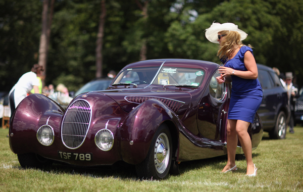 A woman looks at a classic car on the first day at Royal Ascot on June 14, 2011 in Ascot, England. (GETTY)