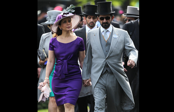 Dubai's Sheikh Mohammed Bin Rashid Al Maktoum and HRH Princess Haya Bint Al Hussein walk together on the first day of the annual  Royal Ascot racve horse meeting at Ascot, England. (AP)