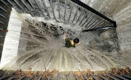 A resident runs on a flooded stairway as floodwater pours into an underground garage amid heavy rainfalls in Chengdu, Sichuan province, July 3, 2011. Heavy downpour hit Chengdu on Sunday, flooding roads and breaking down city traffic. Warnings of further rainstorms and possible floods or landslides have been released, Xinhua News Agency reported. (REUTERS)