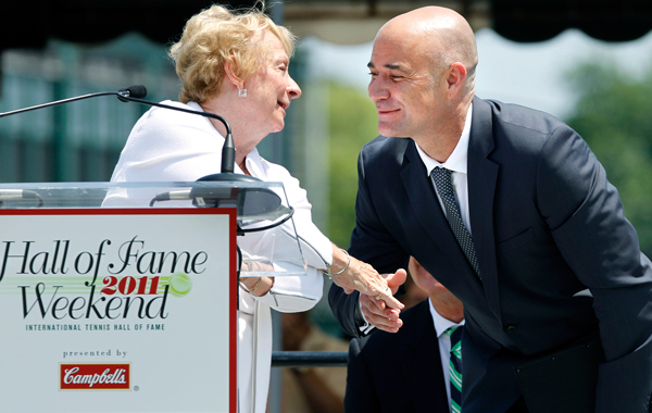 Tennis great Andre Agassi congratulates women's tennis pioneer, Peachy Kellmeyer, of the Women's Tennis Association, during her speech as they both are inducted into the International Tennis Hall of Fame in Newport.R.I. (AP)