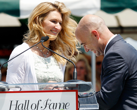 Tennis great Andre Agassi laughs with his wife, Steffi Graf, as he is inducted to the International Tennis Hall of Fame in Newport, R.I. Saturday, July 9, 2011. Graf, of Germany, was inducted into the Hall of Fame in 2004. (AP)