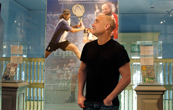 Tennis great Andre Agassi looks around at an exhibit dedicated to him at the International Tennis Hall of Fame in Newport, R.I. Friday, July 8, 2011. Agassi will be inducted into the Hall of Fame Saturday. (AP)