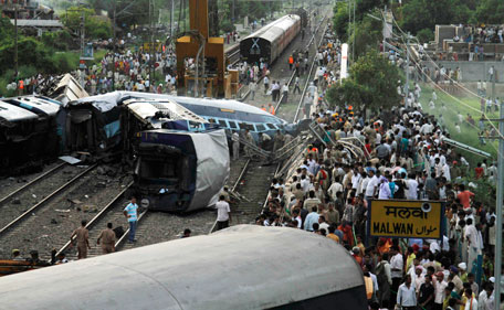 People gather around the wreckage of the Kalka Mail passenger train which derailed near the town of Fatehpur in Uttar Pradesh state, India, Sunday, July 10, 2011. The packed train was on its way to New Delhi from Howrah, a station near Kolkata, when its 12 coaches and the engine jumped the tracks. Dozens of people died and more than 100 are injured, according to officials. (AP)