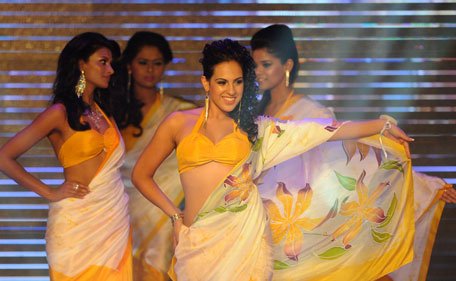 Sri Lankan beauty pageant contestants parade wearing sari during a glittering contest in Colombo on July 11, 2011. The winner will represent Sri Lanka at the Miss Universe pageant 2011. (AFP)