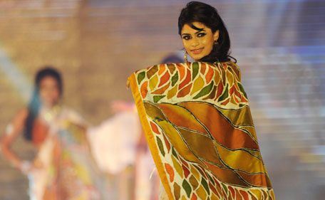 A Sri Lankan beauty pageant contestant parades wearing sari during a glittering contest in Colombo on July 11, 2011. The winner will represent Sri Lanka at the Miss Universe pageant 2011. (AFP)