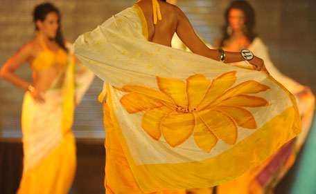 Sri Lankan beauty pageant contestants parade wearing sari during a glittering contest in Colombo on July 11, 2011. The winner will represent Sri Lanka at the Miss Universe pageant 2011.  (AFP)