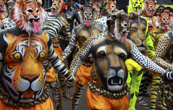 Dancers painted to look like tigers perform during festivities marking the end of the annual harvest festival of "Onam" in Thrissur Kerala. (REUTERS)
