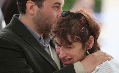 Janis, the mother of Amy Winehouse, is comforted by a friend as she weeps while looking at flowers left by mourners outside Winehouse's home in Camden Square in London, Monday July 25, 2011.  Winehouse 's father Mitch greeted and thanked mourners for coming to lay bouquets, messages and handwritten notes, only hours before police promised to release a post mortem on her death. "This means so much to my family," he said. The 27-year-old singer died Saturday afer publicly struggling with drug and alcohol abuse for years. (AP)