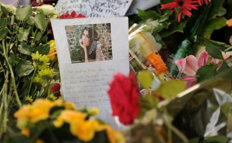 Flowers, pictures and messages are left in tribute to late soul music and British pop star Amy Winehouse, near her home in London, on July 25, 2011. The family of troubled British singer Amy Winehouse said Sunday they have been left "bereft" by her loss at the age of 27 as grieving fans left tributes outside the London home where she was found dead. (AFP)