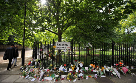 Flowers, pictures and messages left in tribute to late British singer Amy Winehouse are pictured near her house in north London, on July 25, 2011. The family of troubled British singer Amy Winehouse said Sunday they have been left "bereft" by her loss at the age of 27 as grieving fans left tributes outside the London home where she was found dead. (AFP)