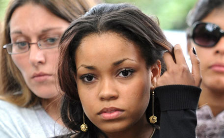 Singer Dionne Bromfield, goddaughter of Amy Winehouse, views tributes outside the late singer's north London home, Tuesday, July 26, 2011. British singer Amy Winehouse's last public appearance came three days before her death, when she briefly joined her goddaughter, singer Dionne Bromfield, on stage at The Roundhouse in Camden. (AP)