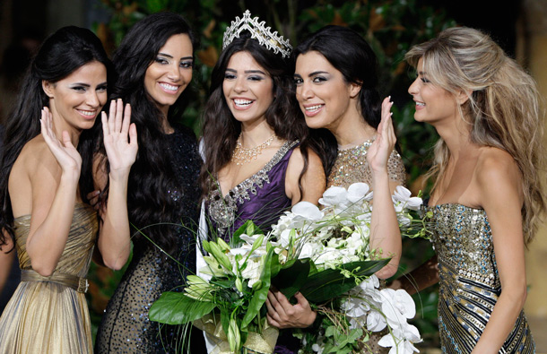 Yara Khoury Mikael, center, newly crowned Miss Lebanon 2011,acknowledges to the audience together with other contestants during the Miss Lebanon 2011 contest in Beirut, Lebanon. (AP)