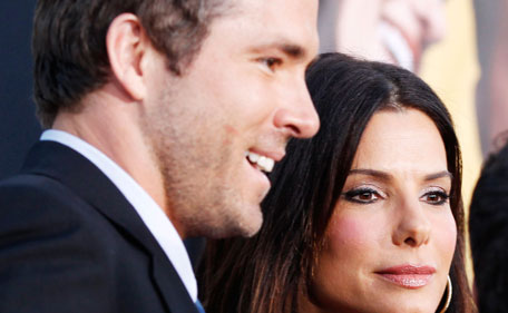Sandra Bullock (R) greets cast member Ryan Reynolds (L) at the world premiere of the film "The Change-Up" in Los Angeles August 1, 2011. (REUTERS)