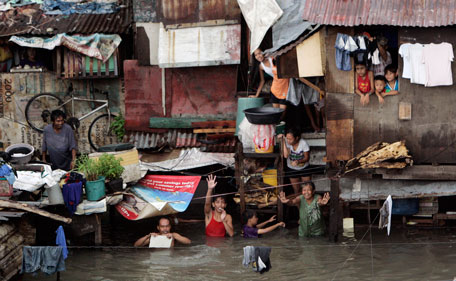Chest-deep flood water submerge a residential area Tuesday, Aug. 2, 2011 in suburban Quezon City, north of Manila, Philippines. A powerful typhoon is blowing away from the northern Philippines after killing at least four people even though it did not make landfall. (AP)