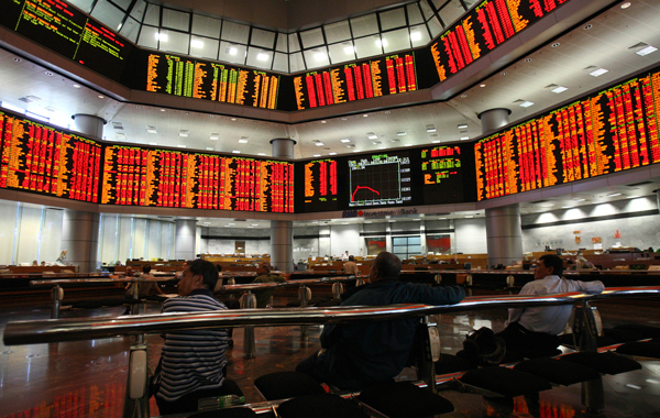 Investors look at stock prices at a private stock market gallery in Kuala Lumpur, Malaysia. Asian stock markets tumbled Friday amid fears the U.S. may be heading back into recession and Europe's debt crisis is worsening. The sell-off follows the biggest one-day points decline on Wall Street since the 2008 financial crisis. (AP)