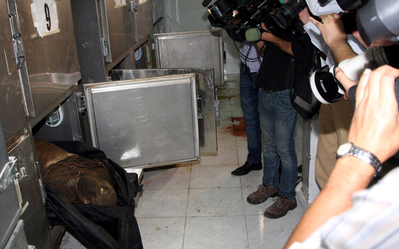 In this photo taken during a government organized tour, journalists photograph the remains of people said to be mostly members of security forces who were killed by members of armed groups, at a government-run hospital in the central city of Hama, Syria. More than 300 people have died in the past week, the bloodiest in the five-month uprising against authoritarian President Bashar Assad. The central city of Hama had been the focus of the crackdown for most of the week. Electricity, Internet and phone lines have been cut for seven days, and residents have reported dwindling food and medical supplies amid frequent shelling and raids. (AP)