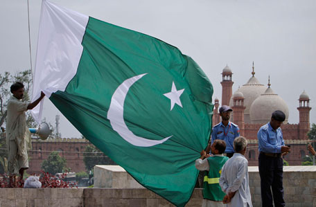Workers hang a Pakistani national flag on a flagpole as part of preparations for the Independence Day celebrations at Pakistani monument or Minar-e-Pakistan in Lahore, Pakistan on Saturday, Aug. 13, 2011. Pakistan will celebrate its 64th Independence Day on Aug. 14, to mark its independence from the British rule in 1947. (AP