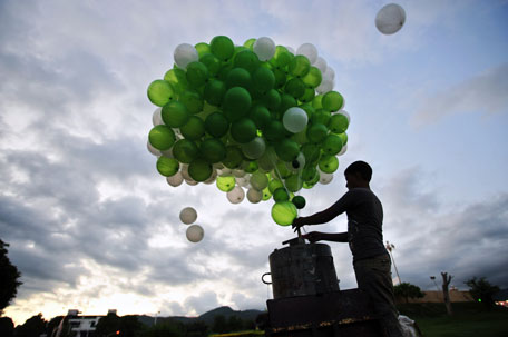 A Pakistani boy inflates green and white balloons, the colours of Pakistan's national flag, near the parliament building in Islamabad on August 13, 2011. The 64th Independence Day will be observed on August 14 throughout the country. (AFP)