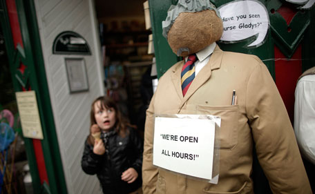 A young girl looks up a scarecrow created to represent the character from the BBC television series 'Open All Hours' stands as part of the annual scarecrow festival on August 13, 2011 in Kettlewell, England. During the two week festival the rural Yorkshire Dales village comes to life with both traditional scarecrows and more modern takes, including parodies of current affairs and celebrities. (GETTY)