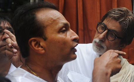 Indian Bollywood actor Amitabh Bachchan (R) speaks with Indian industrialist Anil Ambani during the funeral of the late Bollywood actor Shammi Kapoor in Mumbai on August 15, 2011. Legendary Bollywood heart-throb Shammi Kapoor, whose energetic acting and dancing style heavily influenced modern-day Indian film stars, died on August 14 aged 79.  (AFP)