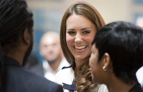 Britain's Catherine, the Duchess of Cambridge (Facing) talks with people as she and husband Prince William visit the Summerfield Community Centre, in Birmingham, central England, following riots in the area last week. (AFP)