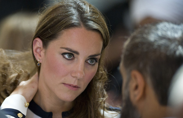 Britain's Catherine, the Duchess of Cambridge (L) talks with people as she and husband Prince William visit the Summerfield Community Centre, in Birmingham, central England, following riots in the area last week. (AFP)
