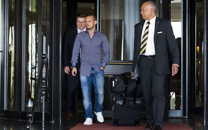 Dutch football national team Wesley Sneijder (L- leaves his hotel in Noordwijk. (SUPPLIED)