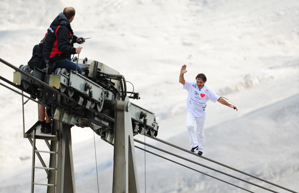 Swiss tightrope artist Freddy Nock performs on the ropes of the Zugspitze cablecar on Germany's highest mountain, the Zugspitze, near Garmisch-Partenkirchen, southern Germany. (AFP)