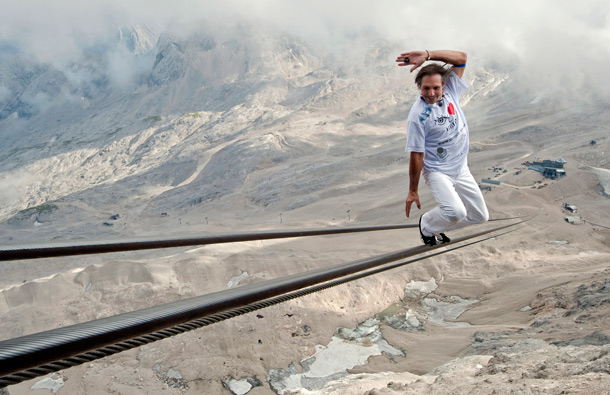 High wire artist Freddy Nock balances as he walks up on the rope of a Zugspitze cable car in Grainau near Garmisch-Partenkirchen, southern Germany. Nock walked up the 995 meters long rope with an altitude difference of 348 meters aiming at collecting money for the UNESCO. (AP)