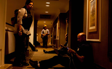 Journalist work in the hallway of the Rixos hotel as gunfire continues around the hotel in Tripoli, Libya, Sunday, Aug 21, 2011. Libyan rebels raced into Tripoli Sunday and met little resistance as Moammar Gaddafi's defenders melted away and his 42-year rule rapidly crumbled.(AP)