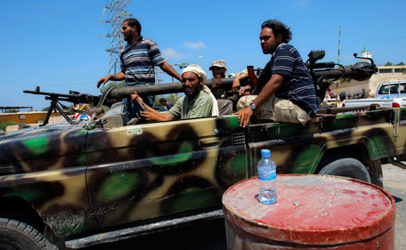 Rebel fighters speed towards the frontline fighting in the village of Mayah, some 30 kilometers west from Tripoli, Libya, Sunday, Aug 21, 2011.  (AP)