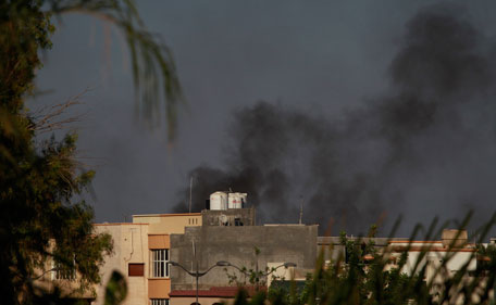 Smoke rises as heavy gunfire is heard all around in Tripoli, Libya, Sunday, Aug 21, 2011. Libyan rebels captured a major military base that defends Moammar Gaddafi's stronghold of Tripoli as clashes and protests raged in the streets of the capital on Sunday. The tide of the 6-month-old civil war appeared to be turning quickly against the leader of more than four decades. (AP)