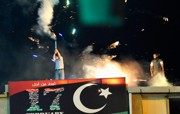 A man lets off fireworks near the courthouse in Benghazi August 22, 2011 to celebrate the entry of rebel fighters into Tripoli. Jubilant rebel fighters streamed into the heart of Tripoli as Muammar Gaddafi's forces collapsed and crowds took to the streets to celebrate, tearing down posters of the Libyan leader.  (REUTERS)