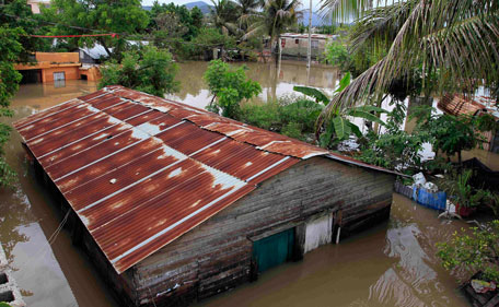 A house in the Moscu neighborhood of San Cristobal, Dominican Republic is seen under water of an overflowed river after the passing of Hurricane Irene on Wednesday, Aug 24, 2010. Flooding, rising rivers and mudslides have prompted the Dominican Republic government to evacuate nearly 38,000 people and more slides were likely in coming days because of days of intense rain from the storm system. (AP)
