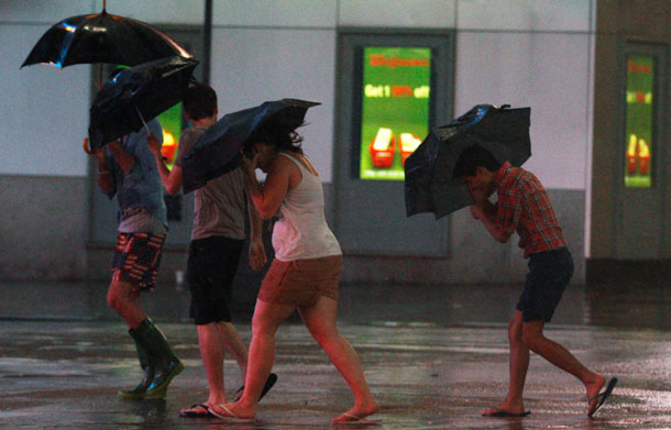 Tourists walk through Times Square as Hurricane Irene arrives in New York, August 27, 2011. Hurricane Irene closed in on New York on Saturday, shutting down the city, and millions of Americans on the East Coast hunkered down as the giant storm halted transport and caused massive power blackouts. (REUTERS)