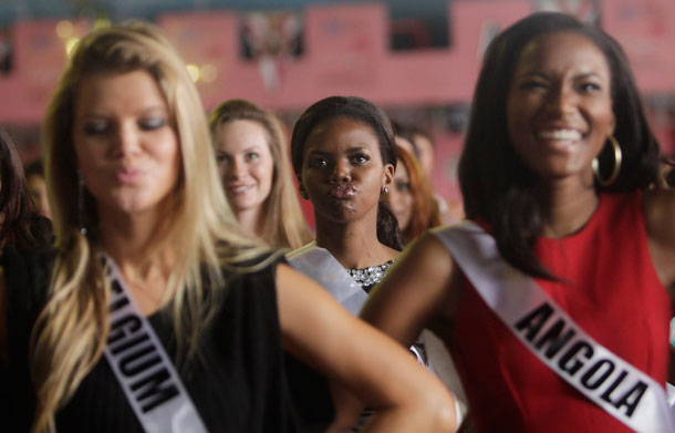 Miss Universe contestants, Botswana's Larona Motlatsi Kgabo, centre, Belgium Justine De Jonckheere, front left, and Angola's Leila Lopesi dance during their visit to a samba school in Sao Paulo, Brazil, Friday Aug. 26, 2011.  The 60th anniversary of the Miss Universe pageant is scheduled for Sept. 12 from Sao Paolo. Last year's winner was Mexico's Jimena Navarrete. (AP)