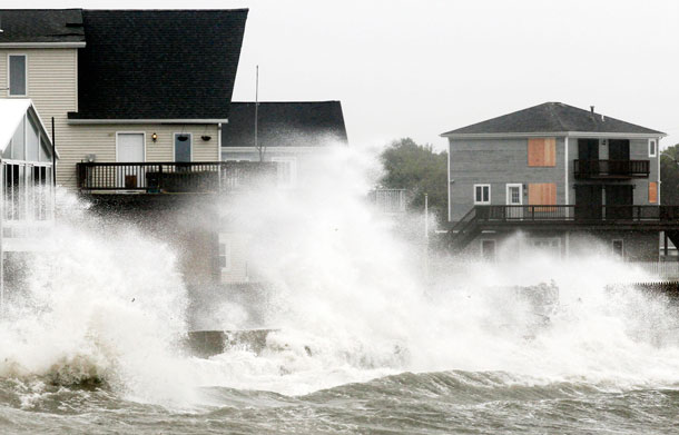 Waves crash along a seawall as Tropical Storm Irene, downgraded from a hurricane, slammed into Fairhaven , Mass. Sunday, Aug 28, 2011. From North Carolina to New Jersey, Hurricane Irene appeared to have fallen short of the doomsday predictions, but more than 4.5 million homes and businesses along the East Coast reportedly lost power, and at least 11 deaths were blamed on the storm. (AP)