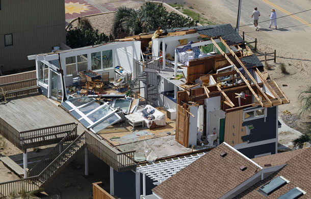 A house damaged by Hurricane Irene is seen in Virginia Beach, Va, Sunday, Aug 28, 2011.  From North Carolina to New Jersey, Hurricane Irene appeared to have fallen short of the doomsday predictions, but more than 4.5 million homes and businesses along the East Coast reportedly lost power, and at least 11 deaths were blamed on the storm. (AP)